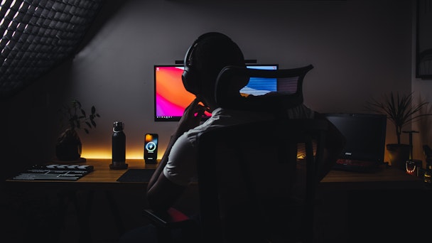 Man sat in dark at computer