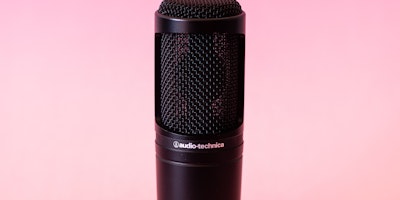Black Audio-Technica microphone on pink background