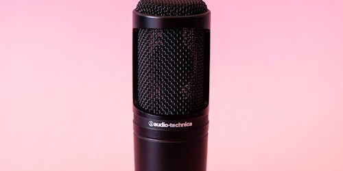 Black Audio-Technica microphone on pink background