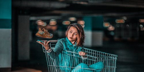 Woman sitting in shopping cart Woman sitting in shopping cart