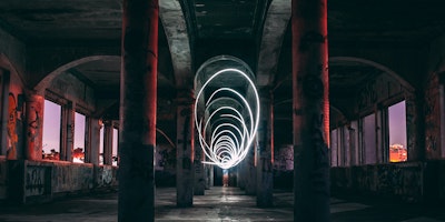 Light shutter effects inside dark graffiti'd tunnel