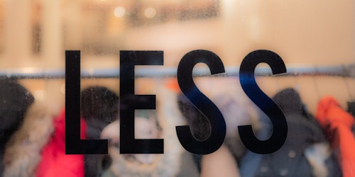 Shop window with 'less' sign