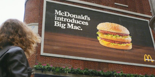 Still from '50 years' of big mac ad showing mcdonald's billboard