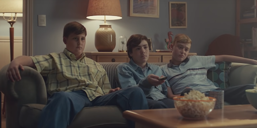 Still from Gillette's 'The Best A Man Can Get' ad showing three boys sitting on a sofa