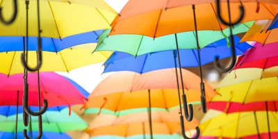 A sea of colourful umbrellas in different positions