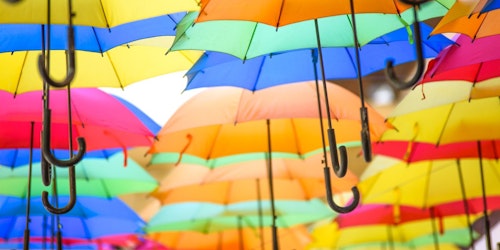 A sea of colourful umbrellas in different positions