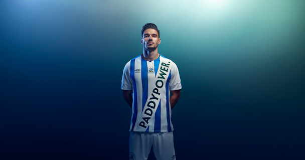 Huddersfield player wearing fake Paddy Power kit against blue background