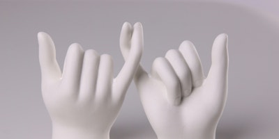 Two white models of hands link little fingers in a gesture that symbolizes a promise being made
