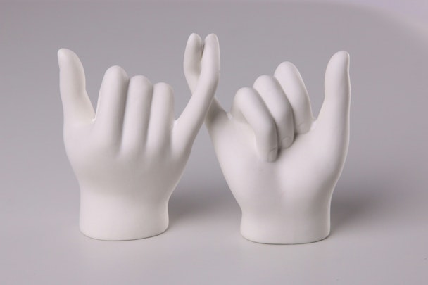 Two white models of hands link little fingers in a gesture that symbolizes a promise being made