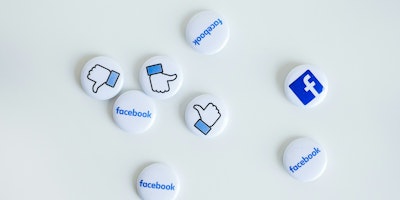 Facebook pin badges scattered on a white background