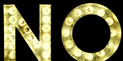Yellow lightbulbs spell out the word 'no' against a black background
