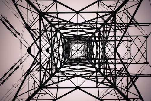 A pylon viewed from below making an abstract pattern
