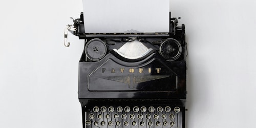 A black Fayorit typewriter against a white background