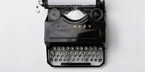 A black Fayorit typewriter against a white background