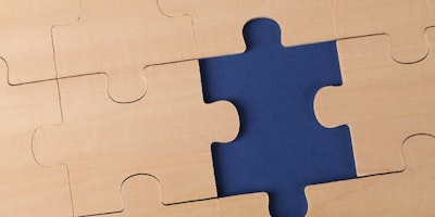 Blue puzzle piece on jigsaw