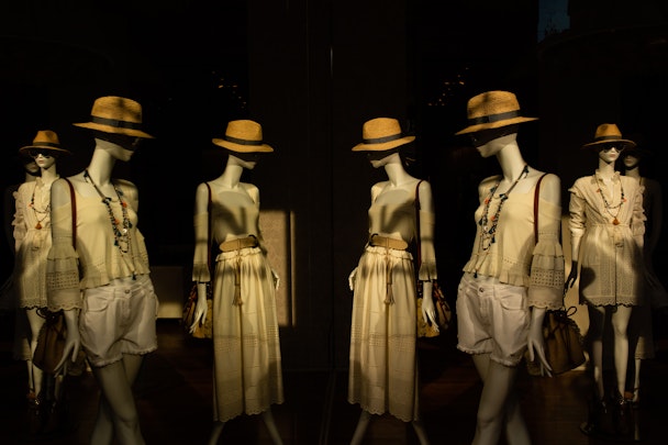 A number of mannequins, wearing different outfits