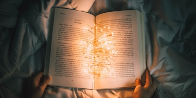 An open book, cradling a wad of fairy lights