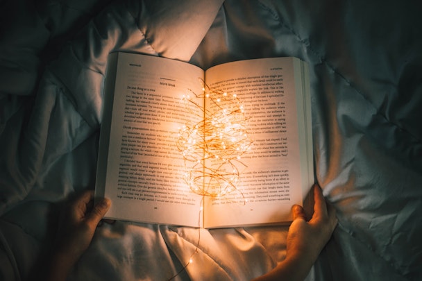 An open book, cradling a wad of fairy lights