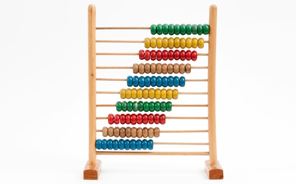 A multicolored wooden abacus against a white background