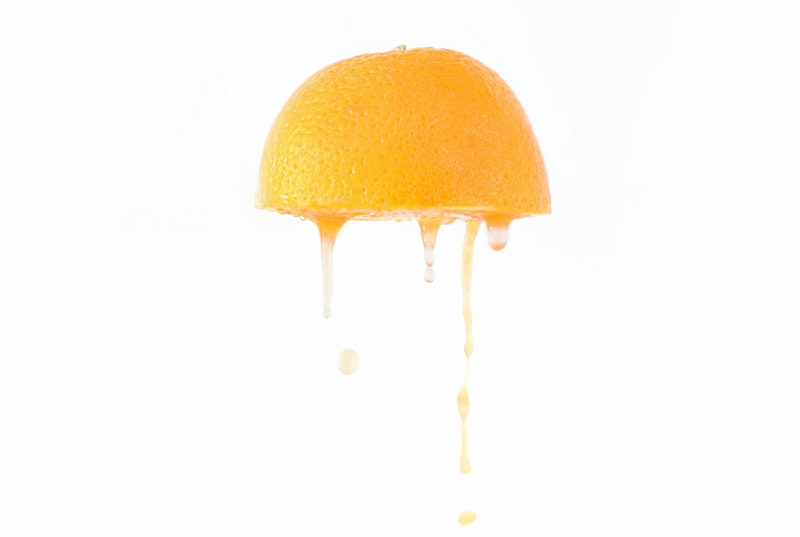 Juice drips from an orange half
