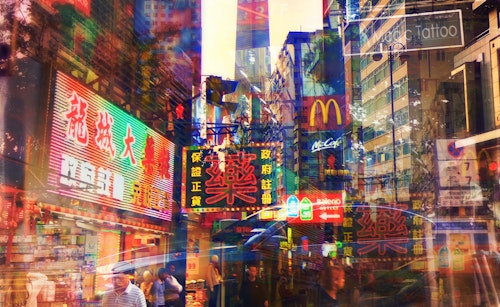 A merged streetscape of neon signs showing brands and Asian writing