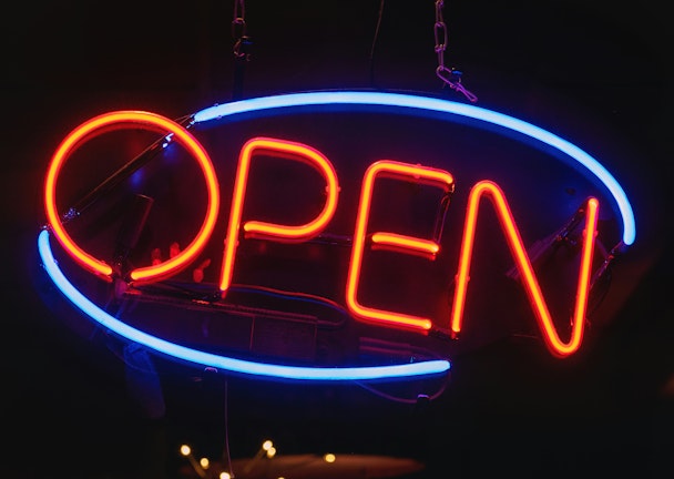 A red and blue neon 'open' sign