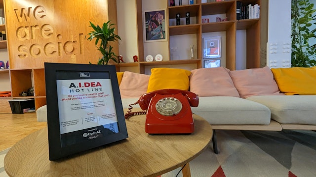 A red telephone on a reception desk