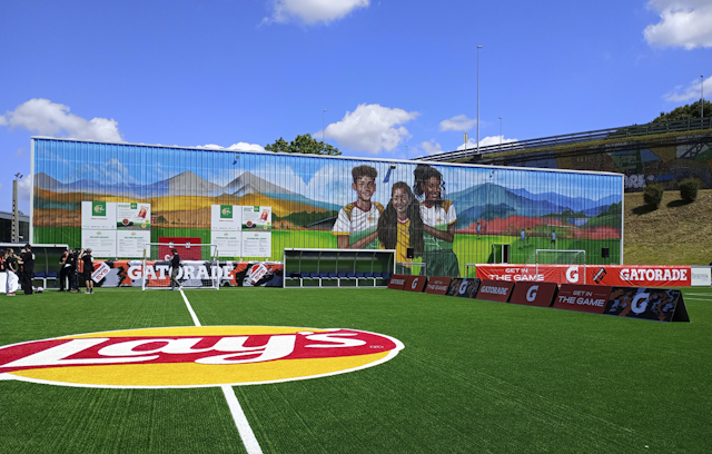 Lays and Gatorade branded football pitch with mural behind