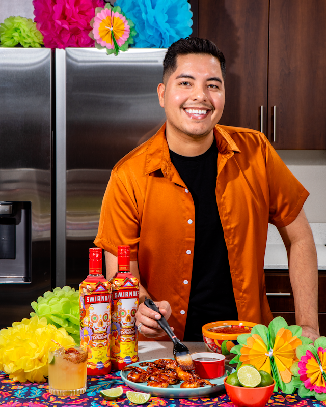 Esteban Castillo making spicy shrimp skewers with Smirnoff vodka products on the table