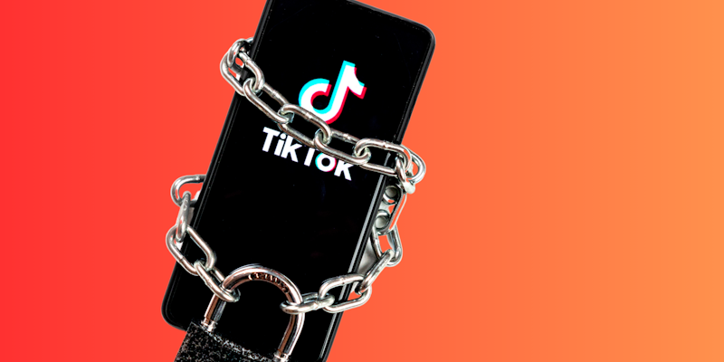 TikTok app on phone in chains and lock