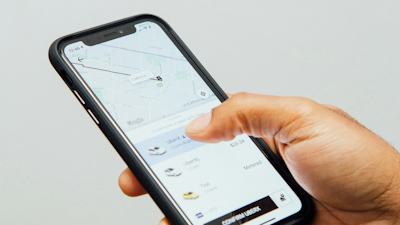 Uber app open on man's mobile phone