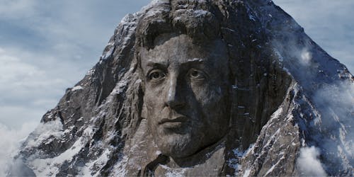 sylvester stallone face in a rock