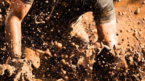 Man runs through a muddy marathon
