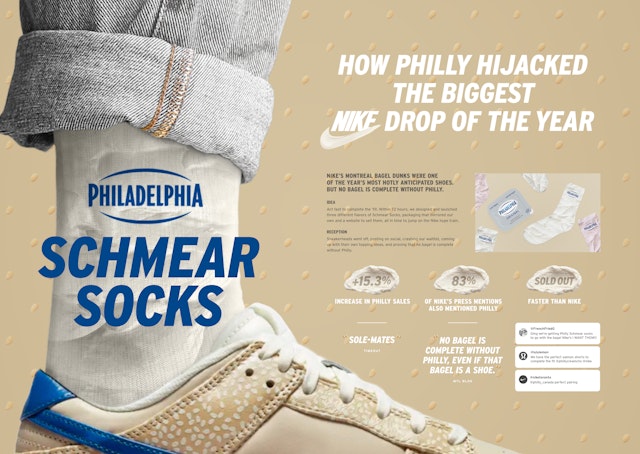 Socks made to look like Philadelphia's Cream Cheese worn with Nike's Montreal Bagel Dunk Lows sneakers, which are made to resemble bagels
